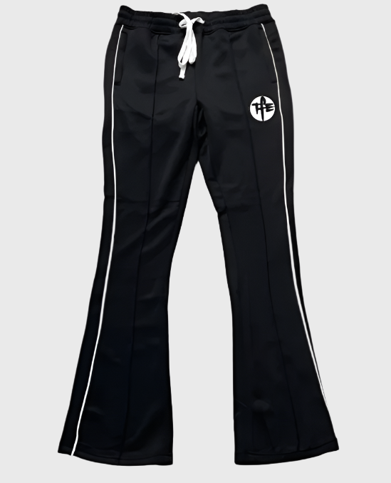 Black track pants with white drawstring and side stripes on a light gray background